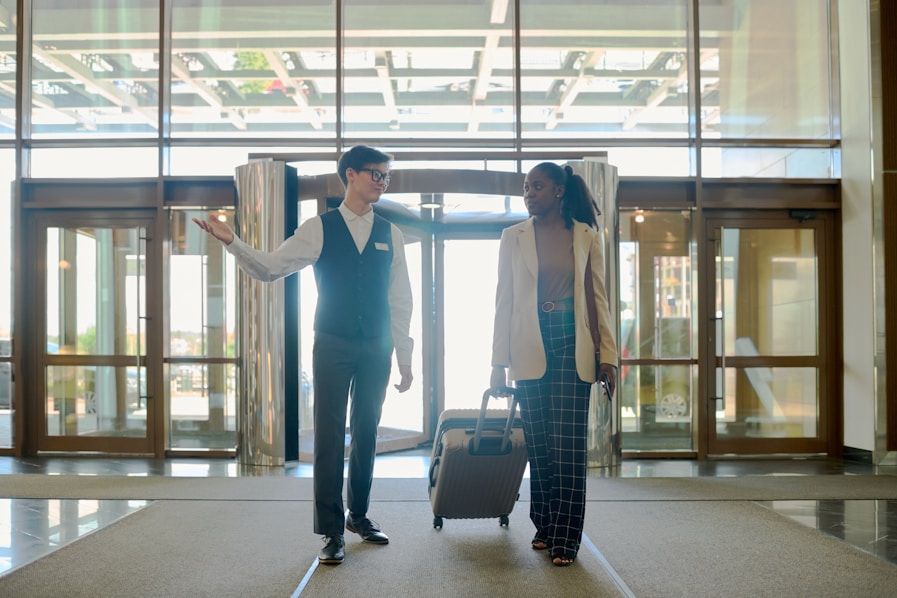 woman entering a hotel and talking with a hotel employee